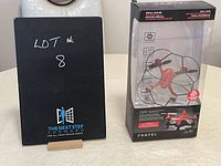 Photo showing the lot number signage and the drone box packaged upright.
