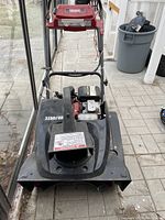 Front view of the Mastercraft single stage snow blower showing black and red housing, air discharge vent, and partially visible Honda engine under the hood.