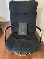 Front view of black corduroy swivel chair showing cushion and chrome base/arms.