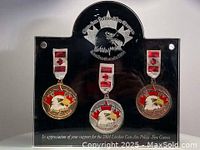 Framed set of three Gun-Am Police-Fire Games medals in gold, silver, and bronze color with ribbons and plaque.