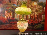 Front view of the floral hand painted glass lamp with shade on, showcasing the overall design and color palette.
