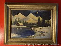 Full view of the large framed winter landscape painting including snow-covered mountains, pine trees, cabin, lake, and full moon