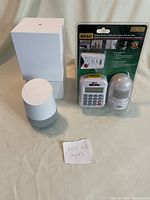 Photo showing Google Home device and new HomeSafe Wireless Home Security Alarm System in package.