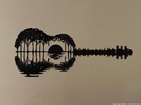 Black cut metal wall hanging shaped like a guitar with intricate cutout water scene
