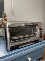 Hamilton Beach stainless steel toaster oven on blue surface
