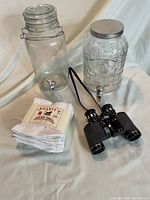 All items laid out showing the juice dispensers, towels, and binoculars