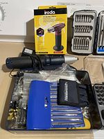 Photo showing iRoda PT-200 Pro Torch box, electric screwdriver, blue and black drill bit cases.