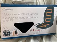 Photo of original box for HealthMate Velour Heated Seat Cushion showing product name and feature image of heated cushion installed in car seat.