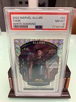 Close-up photo of the front of the 2022 Marvel Allure Thor White Diamond trading card, graded PSA 8, with holographic diamond pattern and image of Thor.