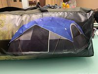 Carrying bag for the tent with image depicting the assembled tent in blue/black/gray colors and mesh windows