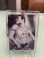 Front view of the Freddie Mercury picture card in the protective acrylic case showing signed image.