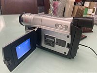 Side view of the JVC digital VHS camcorder with flip-out LCD screen showing display.