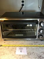 Front view of Black and Decker toaster oven showing the brand logo and overall size.