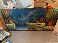 Full view of the landscape painting showing lake, distant mountains, trees with varied foliage colors, and a small house with a reddish roof near a winding path.