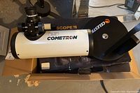 Photo of Cometron FirstScope 76 tabletop telescope partially assembled in the original box