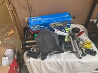 Overview of the bike tools and accessories including foot pump, black mesh pouch, tripod, and bike inner tube box.