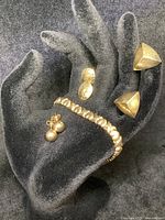 All pieces displayed on black velvet hand stand