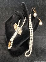 All three pieces displayed on black velvet bust