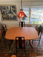 Overhead shot of table in compact configuration with chairs around it
