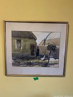 Framed watercolor painting showing a solitary figure near a house and trees against a muted landscape background.