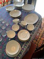 Full set of Rosenthal china dishware on table showing plates, bowls, cups, and serving pieces.