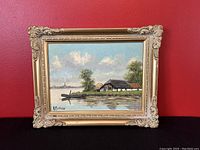 Front view of original signed oil painting depicting a Dutch water scape scene in ornate gesso frame