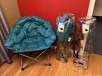 Blue padded club chair unfolded showing padded polyester seat and steel frame.