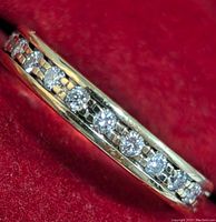 Close-up of band showing row of round diamonds in channel setting