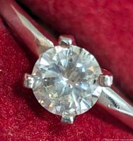 Close-up of round brilliant diamond in six-prong platinum setting