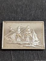 Front of the silver bar showing an embossed three-masted sailing ship.