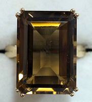 Close-up front view showing the large rectangular step-cut brown Beer Quartz gem on the silver ring.