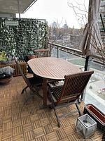 Table and five chairs on balcony