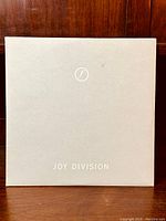 Front face of Joy Division Still double vinyl album cover, light grey with white text and logo.