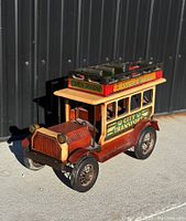 Front angle showing wooden double decker bus with 'City Transport' side signage and 'Colman's Mustard' advertisement on top deck.