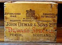Front view of the wooden crate showing the branding and crest with details about the Scotch whisky.