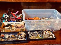 Overview of entire assortment of costume jewelry items in multiple trays and boxes