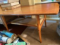 Top and side view of the wooden coffee table showing scratches and overall structure