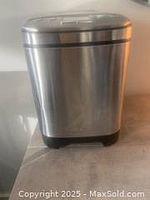 Front view of Cuisinart bread machine showing stainless steel finish and small dent on right front side.