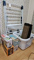 Whole lot assembled - drying rack, laundry basket, irons and other items grouped together