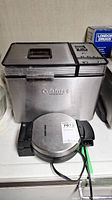 Front view of Cuisinart breadmaker with Black & Decker waffle maker in front