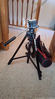 Full view of assembled Velbon D-500 tripod standing on carpet with carry case next to it