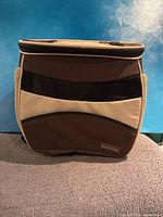 Front view of the pet carrier showcasing mesh panel and brand tag.