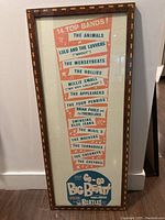 Photo of framed 1964 Go Go Big Beat concert poster listing 14 top bands including The Beatles.