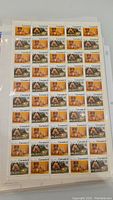Sheet of Canada B stamps showing images of animals and cultural scenes in orange, brown, and green tones.