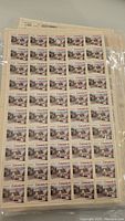 Sheet of Canadian $0.10 stamps with winter village scenes, full intact sheet with 60 stamps.