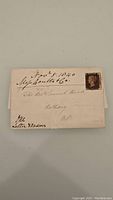 Front view of folded envelope with Penny Black stamp, handwritten address and date visible