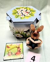 Photo of the wooden bunny figurine, small Easter card, and decorative hexagonal box with floral artwork.