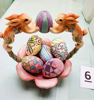 Photo of the 6-piece Easter set showing basket featuring two rabbits holding an egg and five painted decorative eggs inside.