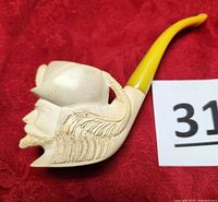 Side profile of the off-white Meerschaum Sultan pipe showing detailed carvings of beard and hat feather with yellow-gold stem.