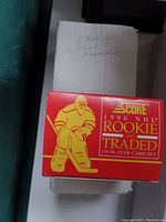 Red box for 1990 NHL Rookie and Traded 110 player card set with illustration of hockey goalie and Score branding.
